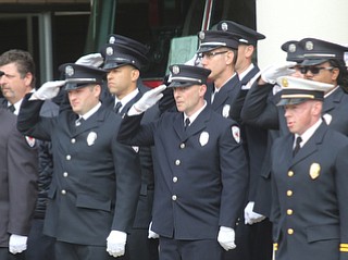     ROBERT K. YOSAY  | THE VINDICATOR..Firefighters salute as the funeral procession passes in front of Fire Station #1..Funeral Services for YFD  Battalion Chief Ron Russo were held Thursday at  Poland United Methodist Church ..The funeral procession then went from PUM to Fire Station  #1 and then to Green Haven  .Russo, 64, was a member of the city fire department for 37 years, working the rescue squad for the majority of his career...-30-