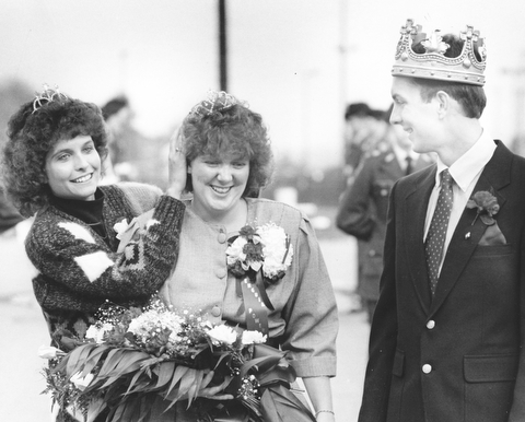 Amy Otley was crowned YSU homecoming queen by last year's queen Sandi Chestnut while Sean McKinney newly crowned homecoming king looks on.