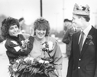Amy Otley was crowned YSU homecoming queen by last year's queen Sandi Chestnut while Sean McKinney newly crowned homecoming king looks on.