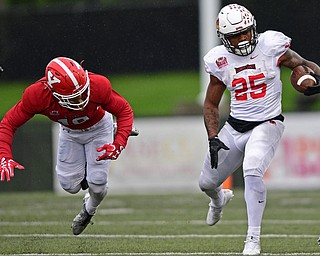 YOUNGSTOWN, OHIO - OCTOBER 28, 2017: Illinois State's James Robinson, right, side steps away from Youngstown State's Kyle Hegedus during the first half of their game, Saturday afternoon at Stambaugh Stadium. Illinois State won 35-0. DAVID DERMER | THE VINDICATOR