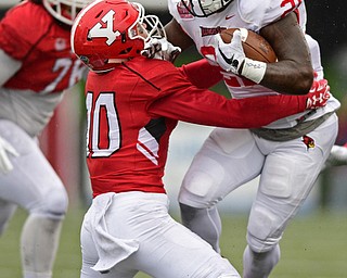 YOUNGSTOWN, OHIO - OCTOBER 28, 2017: Illinois State's Markel Smith, right, runs over Youngstown State's Kyle Hegedus during the first half of their game, Saturday afternoon at Stambaugh Stadium. Illinois State won 35-0. DAVID DERMER | THE VINDICATOR