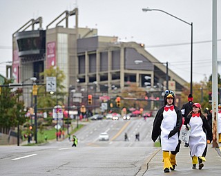 YOUNGSTOWN, OHIO - OCTOBER 28, 2017: Ashley Milligan and Brad Smith, both from Canfield, walk down Fifth Avenue near the parade route waiting for the start of the YSU homecoming parade, Saturday afternoon. DAVID DERMER | THE VINDICATOR