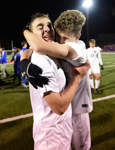 Howland's Gabe Altawil gets a hug from teammate Matt Seem after scoring the game winning shootout goal to defeat Lakeview. DAVID DERMER | THE VINDICATOR