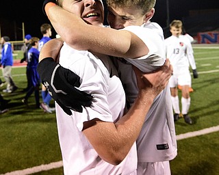 Howland's Gabe Altawil gets a hug from teammate Matt Seem after scoring the game winning shootout goal to defeat Lakeview. DAVID DERMER | THE VINDICATOR