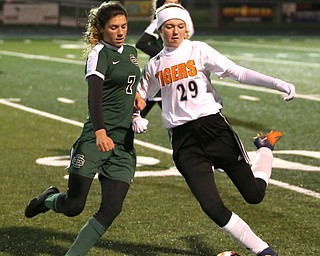 Springfield Local midfielder Anna Rothwell (29) attempts to keep the ball away from Elyria Catholic midfielder Avery Doll (7) during the first half as Elyria Catholic High School takes on Springfield Local High School in the Division III Region 9 Regional Semi-Finals, Tuesday, Oct. 31, 2017, at Green Memorial Stadium in Uniontown. Elyria won 6-0...(Nikos Frazier | The Vindicator)..