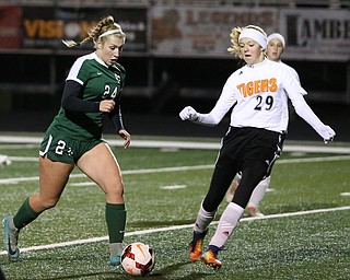 Elyria Catholic midfielder Makenna Hodges (24) drives towards the net as Springfield Local midfielder Anna Rothwell (29) tries to steal the ball away during the first half as Elyria Catholic High School takes on Springfield Local High School in the Division III Region 9 Regional Semi-Finals, Tuesday, Oct. 31, 2017, at Green Memorial Stadium in Uniontown. Elyria won 6-0...(Nikos Frazier | The Vindicator)..