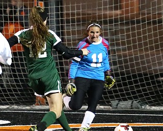 Elyria Catholic forward Ryan Kunkle (12) scores a goal against Springfield Local goalie Lex Slike (11) during the first half as Elyria Catholic High School takes on Springfield Local High School in the Division III Region 9 Regional Semi-Finals, Tuesday, Oct. 31, 2017, at Green Memorial Stadium in Uniontown. Elyria won 6-0...(Nikos Frazier | The Vindicator)..