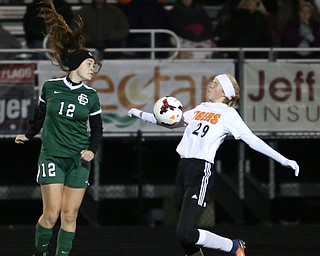 Springfield Local midfielder Anna Rothwell (29) uses her chest to regain control of the ball against Elyria Catholic forward Ryan Kunkle (12) during the first half as Elyria Catholic High School takes on Springfield Local High School in the Division III Region 9 Regional Semi-Finals, Tuesday, Oct. 31, 2017, at Green Memorial Stadium in Uniontown. Elyria won 6-0...(Nikos Frazier | The Vindicator)..
