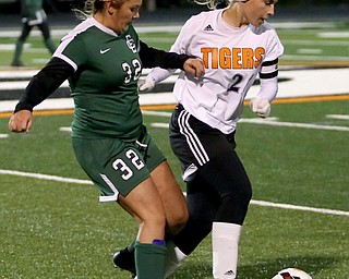 Springfield Local midfielder Cierra Latronica (24) tries to keep the ball away from Elyria Catholic midfielder Meredith Flanagan (32) during the second half as Elyria Catholic High School takes on Springfield Local High School in the Division III Region 9 Regional Semi-Finals, Tuesday, Oct. 31, 2017, at Green Memorial Stadium in Uniontown. Elyria won 6-0...(Nikos Frazier | The Vindicator)..