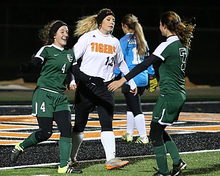 Elyria Catholic forward Emilie Uhnak (4) is congradulated by Elyria Catholic midfielder Avery Doll (7) after scoring a goal against Springfield Local goalie Lex Slike (11) during the second half as Elyria Catholic High School takes on Springfield Local High School in the Division III Region 9 Regional Semi-Finals, Tuesday, Oct. 31, 2017, at Green Memorial Stadium in Uniontown. Springfield Local defender Hayley Socha (12) walks by in the center. Elyria won 6-0...(Nikos Frazier | The Vindicator)..