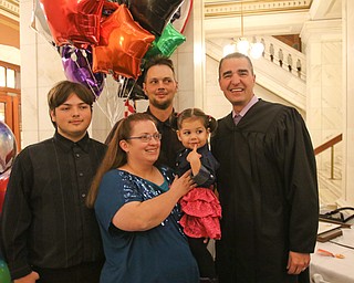 ROBERT K. YOSAY | THE VINDICATOR..the new family... . Jakob ()ok) shawn Teresa and Jacqueline Wolfe and Judge Robert N Rusu Jr..A young girl found a new home as Judge Robert N. Rusu of Mahoning County Probate Court presided over her adoption in the courthouse rotunda during the countyÕs fourth Adoption Day celebrationÓ ...-30-