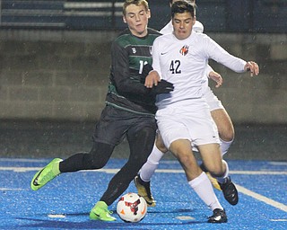 WILLIAM D LEWIS | THE VINDICATOR..Howlands #42Chris Rubion and Aurora #12 Cade Huffman battle for the ball behind them is Howland #7 Stevan Gilsic (hidden) Division II regional semifinal boys soccer Howland vw Aurora at Ravenna Stadium..-30-