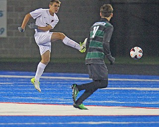 WILLIAM D LEWIS | THE VINDICATOR..Howland #33 Gabe Altawil moves the ball away from Aurora Defender #11 Nate Malinowski during Division II regional semifinal boys soccer Howland vw Aurora at Ravenna Stadium..-30-