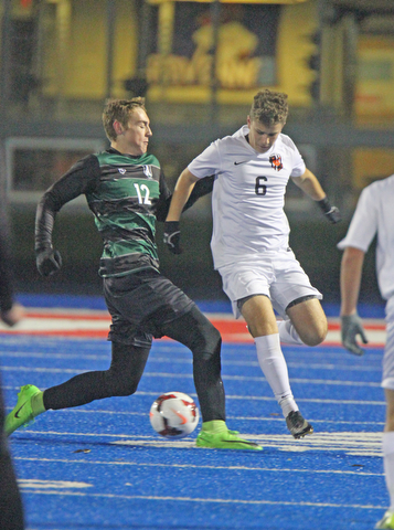   WILLIAM D LEWIS  | THE VINDICATOR..Aurora #12 Cade Huffman and Holwand #6 Matt Seem  battle for the ball in first half action at Division II regional semifinal boys soccer Howland vw Aurora at Ravenna Stadium..-30-