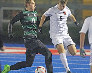 WILLIAM D LEWIS | THE VINDICATOR..Aurora #12 Cade Huffman and Holwand #6 Matt Seem battle for the ball in first half action at Division II regional semifinal boys soccer Howland vw Aurora at Ravenna Stadium..-30-