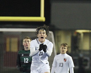   WILLIAM D LEWIS  | THE VINDICATOR..Howlands #11  heads the ball away from Auroras #12 Cade Huffman asHowlands #13  Cameron Sperling looks on..Division II regional semifinal boys soccer Howland vw Aurora at Ravenna Stadium..-30-