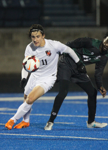   WILLIAM D LEWIS  | THE VINDICATOR..Howlands #11 Jonah Wiseman chases after the ball as  Aurora #49  Alex Bibza  looks on..Division II regional semifinal boys soccer Howland vw Aurora at Ravenna Stadium..-30-