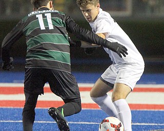 WILLIAM D LEWIS | THE VINDICATOR..Howlands #6 Matt Seem and Aurora #11 Nate Malinowski battle for the ball during first half action at Division II regional semifinal boys soccer Howland vw Aurora at Ravenna Stadium..-30-