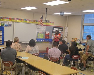Neighbors | Zack Shively.Kindergarten teacher Kendra Gura explained what the students are learning to parents of her students. Gura and the parents discussed the new math program and what the students have learned and will be learning.