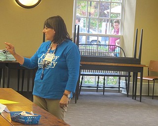 Neighbors | Zack Shively.Librarian Karen Steed taught children at the library how to sign different letters in American Sign Language for Poland Library's Snack N Sign event on Sept. 29.