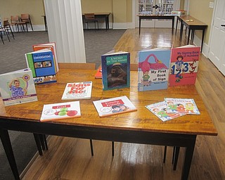 Neighbors | Zack Shively.Librarian Karen Steed placed books out for the students to check out based around American Sign Language for the Snack N Sign event on Sept. 29.