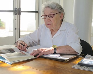 Neighbors | Zack Shively.Shirley Bartlett, member of the "...And the Rest is History" book club, examined pictures from the memoir that Jones shared at the meeting. Bartlett delivered stories from her personal history that recollected her memories of World War II at the meeting.