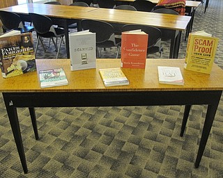 Neighbors | Zack Shively.Austintown library put out books relating to protection from identity theft and scam artists during a guest lecture from the Better Business Bureau about fraud and scams.