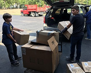 Neighbors | Submitted .Glenwood students Caleb Austin and Jared Mahood load boxes full of donations for Mission of Love.