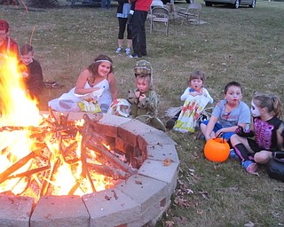 Neighbors | Zack Shively.Volunteers of the Woodside Community Garden made a bonfire for families to sit around and eat their snacks. They hope that the garden will develop into a common place for community events.