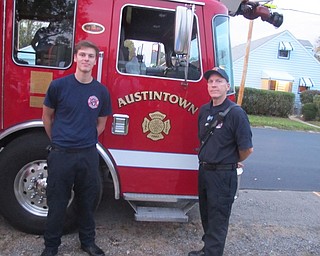 Neighbors | Zack Shively.The fire department came to the Fall Festival and Craft Show on Oct. 21 to monitor the bonfire and spread information regarding fire safety as a part of fire prevention month. Pictured are, from left, firefighter Cameron Long and Lieutenant Mike NcNally. They also let children into the truck and showed them some of their equipment.