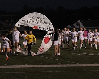 Neighbors | Submitted.The five Canfield High School girls soccer team seniors led their team in running through a hoop banner prior to their game against Austintown Fitch during Senior Night on Oct. 9.