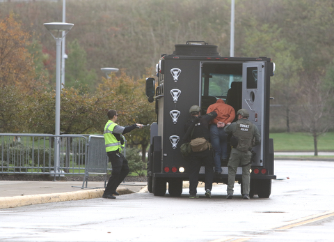   ROBERT K YOSAY  | THE VINDICATOR..The Mahoning Valley Crisis Response Team/SWAT consisting of police officers from the three counties along with YFD and STATMedEvac  had a mock scenario at the Covelli center. The SWAT exercise was to test new radios and equipment as well as prepare for an actual event..a suspect/casualty is brought out of the building.-30-
