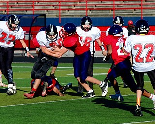 Neighbors | Submitted .Canfield Village Middle School Fullback Dom Marzano (30) fights for yardage against Austintown Middle.