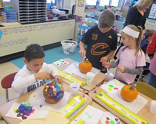 Neighbors | Zack Shively.The Poland Union Elementary PTO held an art class where the students decorated pumpkins on Oct. 24. Students, from left, Colin Sacui, Christopher Holtzman and Haritina Rohan used pompoms, paint and glitter to decorate their pumpkins.
