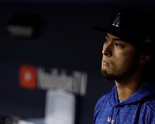 Los Angeles Dodgers' Yu Darvish watches from the dugout during the eighth inning of Game 7 of baseball's World Series against the Houston Astros Wednesday, Nov. 1, 2017, in Los Angeles. (AP Photo/Matt Slocum)