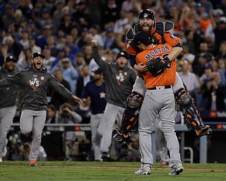 Houston Astros catcher Brian McCann leaps in the arms of starting pitcher Charlie Morton after Game 7 of baseball's World Series against the Los Angeles Dodgers Wednesday, Nov. 1, 2017, in Los Angeles. The Astros won 5-1 to win the series 4-3. (AP Photo/Matt Slocum)