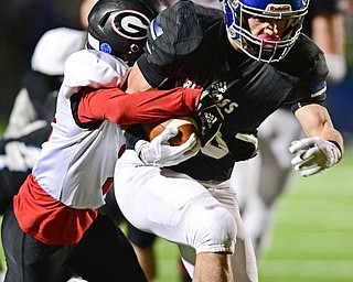 CORTLAND, OHIO - NOVEMBER 3, 2017: Lakeview's Tony Crish, front, runs the ball while being tackled by Girard's Devin Wilson during the first half of the OHSAA playoff game, Friday night at Lakeview High School. DAVID DERMER | THE VINDICATOR
