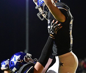 CORTLAND, OHIO - NOVEMBER 3, 2017: Lakeview's Evan Adair, top, is lifted by Danny Brammer after scoring a touchdown during the first half of the OHSAA playoff game, Friday night at Lakeview High School. DAVID DERMER | THE VINDICATOR