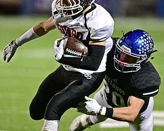 CORTLAND, OHIO - NOVEMBER 3, 2017: Girard's Aiden Warga runs the ball while being tackled by Lakeview's Tony Crish during the first half of the OHSAA playoff game, Friday night at Lakeview High School. DAVID DERMER | THE VINDICATOR