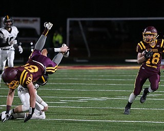 South Range's Mathias Combs(18) runs the ball as South Range's Jacob Gehring(80) is flipped over by Crestview's Chucky Lindsay(51) during the first quarter as Crestview High School takes on South Range High School, Friday, Nov. 3, 2017, at Raider's stadium at the Rominger Sports Complex in Canfield...(Nikos Frazier | The Vindicator)..