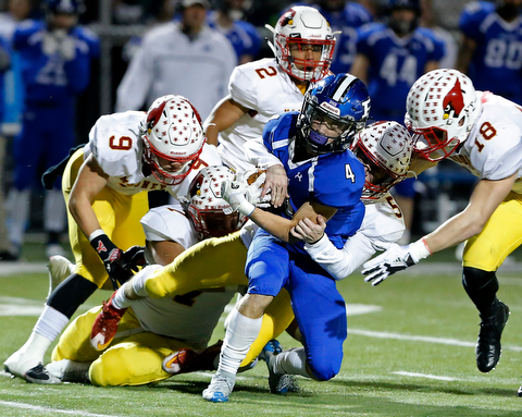 POLAND, OHIO - NOVEMBER 3, 2017:   Poland's Mike Diaz (4) is stopped after picking up a 1st down by Mooney's Nico Marchionda (5) during the1st qtr. at Poland Stadium. MICHAEL G TAYLOR | THE VINDICATOR