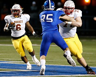 POLAND, OHIO - NOVEMBER 3, 2017:   Mooney's Andre McCoy (6) runs for a 1st down as his teammate Kyle Jornigan (72) blocks Poland's Nick Miller (85) during the1st qtr. at Poland Stadium. MICHAEL G TAYLOR | THE VINDICATOR