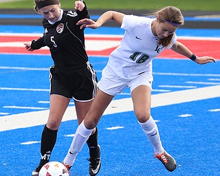 Lake Catholic defender Julia Marusic (18) and Canfield forward Marisa Scheetz (5) fight for the ball during the first half as Lake Catholic High School takes on Canfield High School in the Division II Regional Final, Saturday, Nov. 4, 2017, at Gilcrest Field at Portage Community Bank Stadium in Ravenna, Ohio. Lake won 2-0...(Nikos Frazier | The Vindicator)..