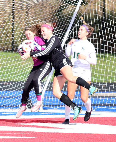 Canfield defender Ally Stein (24) collides with Lake Catholic goalie Kennedy Solymosi (21) during the second half as Lake Catholic High School takes on Canfield High School in the Division II Regional Final, Saturday, Nov. 4, 2017, at Gilcrest Field at Portage Community Bank Stadium in Ravenna, Ohio. Lake won 2-0...(Nikos Frazier | The Vindicator)..