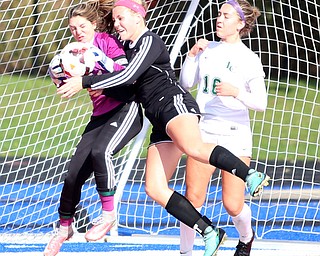 Canfield defender Ally Stein (24) collides with Lake Catholic goalie Kennedy Solymosi (21) during the second half as Lake Catholic High School takes on Canfield High School in the Division II Regional Final, Saturday, Nov. 4, 2017, at Gilcrest Field at Portage Community Bank Stadium in Ravenna, Ohio. Lake won 2-0...(Nikos Frazier | The Vindicator)..