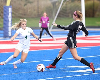 Canfield defender Camryn Kohout (20) goes up against Lake Catholic defender Kennedy Rieple (4) during the second half as Lake Catholic High School takes on Canfield High School in the Division II Regional Final, Saturday, Nov. 4, 2017, at Gilcrest Field at Portage Community Bank Stadium in Ravenna, Ohio. Lake won 2-0...(Nikos Frazier | The Vindicator)..
