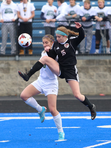 Canfield defender Ellie Accordino (16) kicks the ball as she clears Lake Catholic forward Keka Babic (9) during the second half as Lake Catholic High School takes on Canfield High School in the Division II Regional Final, Saturday, Nov. 4, 2017, at Gilcrest Field at Portage Community Bank Stadium in Ravenna, Ohio. Lake won 2-0...(Nikos Frazier | The Vindicator)..