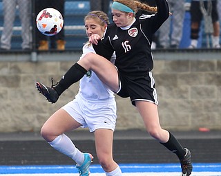 Canfield defender Ellie Accordino (16) kicks the ball as she clears Lake Catholic forward Keka Babic (9) during the second half as Lake Catholic High School takes on Canfield High School in the Division II Regional Final, Saturday, Nov. 4, 2017, at Gilcrest Field at Portage Community Bank Stadium in Ravenna, Ohio. Lake won 2-0...(Nikos Frazier | The Vindicator)..