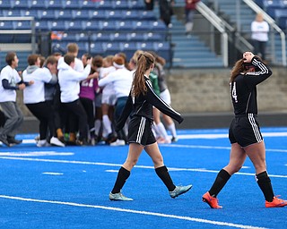 Canfield players look back as the Lake Catholic students storm the field after Lake Catholic High School defeated Canfield High School in the Division II Regional Final, Saturday, Nov. 4, 2017, at Gilcrest Field at Portage Community Bank Stadium in Ravenna, Ohio...(Nikos Frazier | The Vindicator)..