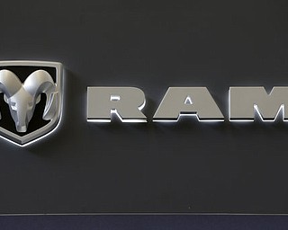FILE - In this Feb. 14, 2013 photo, the Dodge Ram truck logo appears on a sign at the 2013 Pittsburgh Auto Show in Pittsburgh.  Fiat Chryslerâ€™s U.S. division is recalling approximately 1 million trucks because of a potential software glitch that could be experienced during a vehicle rollover. The recall includes certain 2013-16 Ram 1500 and 2500 pickups and 2014-2016 Ram 3500 pickups in the U.S. It also affects about 216,007 vehicles in Canada, 21,668 in Mexico and 21,530 outside the NAFTA region. (AP Photo/Gene J. Puskar)